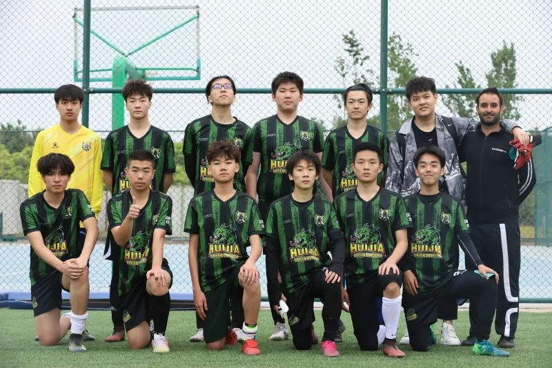 Players and a coach from the Beijing Huijia High School football team